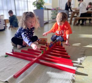 Young boy and girl playing with Montessori learning tool